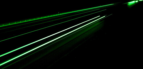 green car lights at night. long exposure