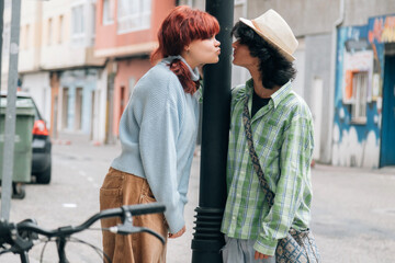 teenage couple giving each other a loving kiss on the street
