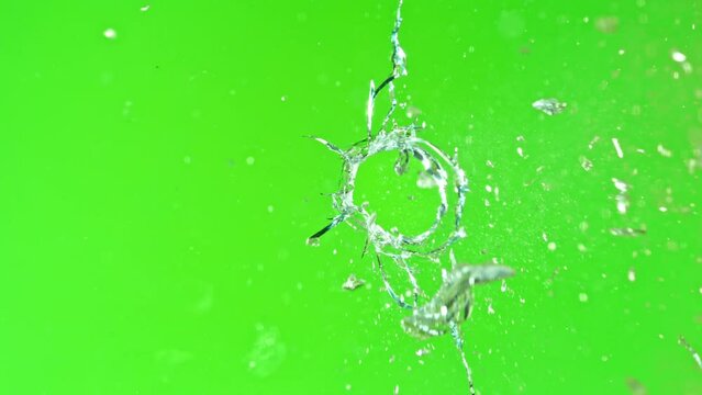 Super slow motion of gunshot through the glass, shattering against green screen background . Filmed on high speed cinema camera, 1000 fps.