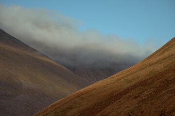 High mountains slopes shrouded in cloud. Scottish Highlands
