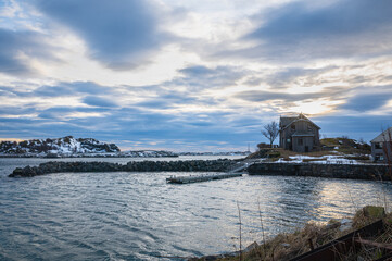 Lonely house on a Nordic fjord near the fishing village of Henningsvær on the Lofoten Islands, northern Norway
