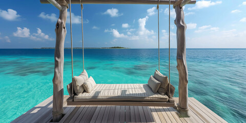 comfy swing over turquoise ocean water and blue sky on tropical island