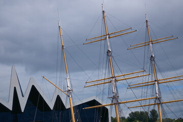 The masts of an old sailing ship moored to the pier. The Tall Ship at Glasgow Harbour