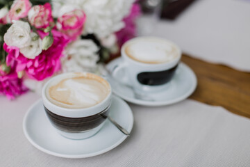 Two cups of cappuccino with elegant latte art, perfect for social meet-ups and coffee breaks