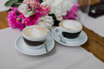 Two cups of cappuccino with elegant latte art, perfect for social meet-ups and coffee breaks