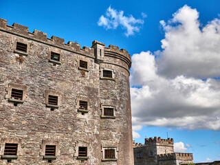 Old celtic castle tower and a house. Ancient Irish architecture background