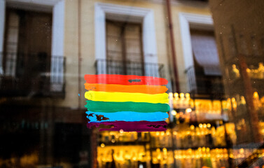 Rainbow flag drawn with different colors on a glass front door of a cafe, restaurant. Gay friendly...
