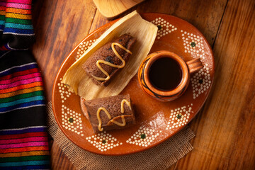 Chocolate Tamale. hispanic dish typical of Mexico and some Latin American countries. Corn dough wrapped in corn leaves. The tamales are steamed. Usually accompanied with atole, hot chocolate or coffee - 762675745