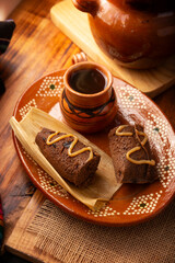 Chocolate Tamale. hispanic dish typical of Mexico and some Latin American countries. Corn dough wrapped in corn leaves. The tamales are steamed. Usually accompanied with atole, hot chocolate or coffee - 762675779