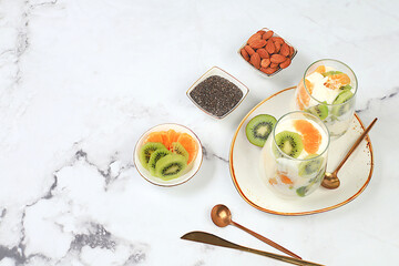 Strawberry yogurt with berries, French cracker and granola on a bright table, fruit salad, detox diet and natural nutrition concept, Healthy breakfast with ingredients. lifestyle, baby food,