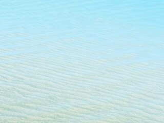 Blue clear water on sandy beach 