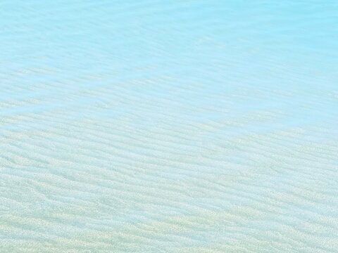 Blue clear water on sandy beach 