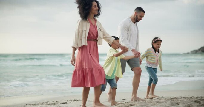 Parents, children and holding hands for walk on beach with smile, care and bonding on vacation in summer. Father, mother and kids with connection, love and outdoor by ocean, sand and happy in Brazil