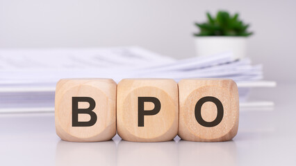 BPO text on wooden cubes on the gray background. Business Process Outsourcing concept
