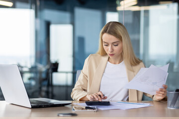 Professional businesswoman working with documents at office desk