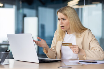 Woman confused by online payment on her laptop