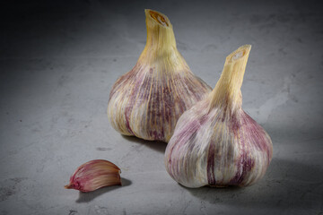 Still life photo of organic whole garlic on a light stone background 3