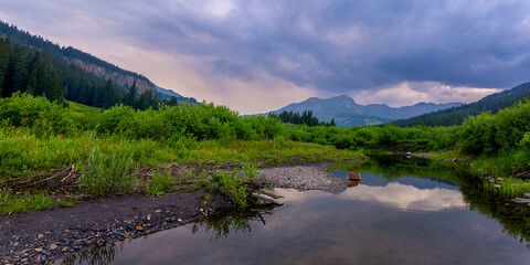 Scenic landscape of Colorado rocky mountains in twilight during summer time .