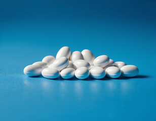 Close-up of a set of white pills on a blue background