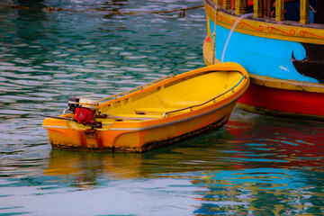 Yellow and Orange Boat Floats on Green Water