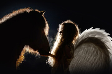 Romantic scenery of a woman and her horse - night photography of an angel and a icelandic horse
