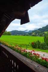 Look out from a balcony of a traditional German Fachwerkhäuser with mountain and flower in black...