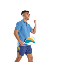 asian boy in blue sportswear holding pickleball paddle with victory gesture on white background