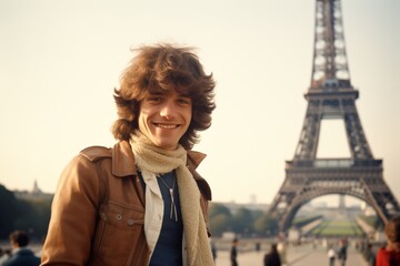 Young caucasian man smiling at Eiffel Tower in Paris in 1970s