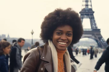  Black woman smiling at Eiffel Tower in Paris in 1970s © blvdone