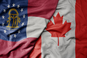 big waving realistic national colorful flag of georgia state and national flag of canada .