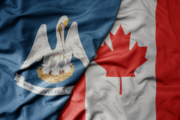 big waving realistic national colorful flag of louisiana state and national flag of canada .