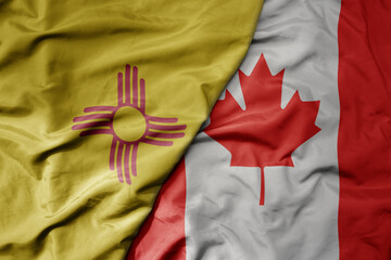 big waving realistic national colorful flag of new mexico state and national flag of canada .