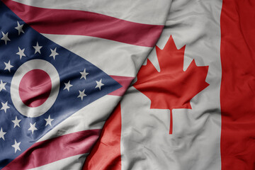 big waving realistic national colorful flag of ohio state and national flag of canada .