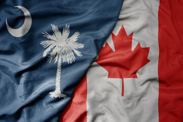 big waving realistic national colorful flag of south carolina state and national flag of canada .