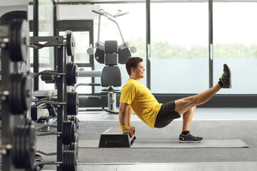 Man exercising with a step aerobic platform