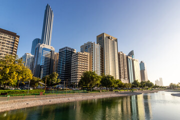 Fototapeta na wymiar Abu Dhabi skyline from The Lake Park, United Arab Emirates.