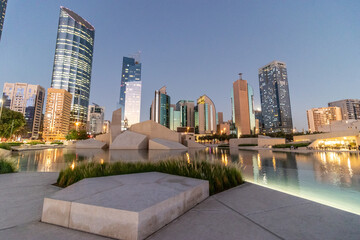Evening view of skyscrapers and Musalla Al Hosn mosque in Abu Dhabi downtown, United Arab Emirates.