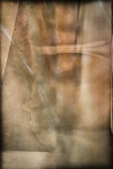 An abstract background with a grunge texture and a blend of earthy colors that convey age and mystery