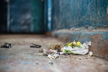 a lot of garbage on the floor in the hallway of the hostel. front and background blurred with bokeh...