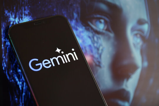 KYIV, UKRAINE - MARCH 17, 2024 Gemini logo on iPhone display screen with background of artificial intelligence futuristic ai generated image close up