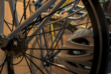 close up of bike on rack helmet storage bike room wheels spokes ride transport brakes fixie cyclist road safety gears chain tire