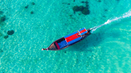 Traditional Thai longtail boat in the shallow waters of Phi Phi island, Krabi, Thailand. Boat tour...