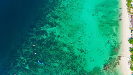 Long beach at Koh Phi Phi island, Krabi, Thailand. Tropical paradise white sand beach with turquoise waters of Andaman sea, aerial view. 