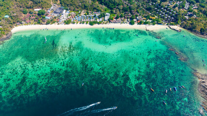 Long beach at Koh Phi Phi island, Krabi, Thailand. Tropical paradise white sand beach with turquoise waters of Andaman sea, aerial view. 