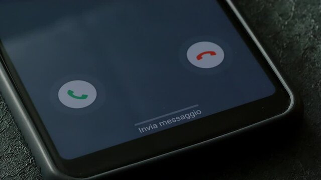 closeup phone with incoming call on the screen over a table