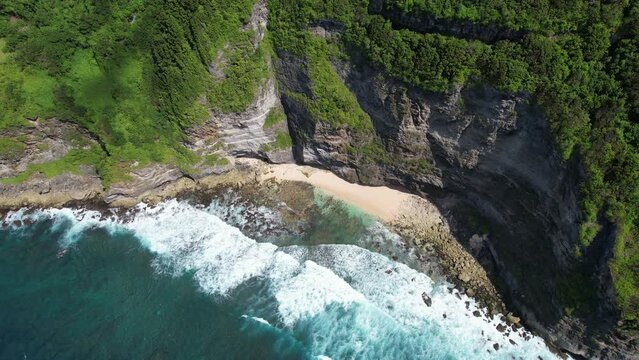 Tilt down aerial shot of Samsara beach on sunny day. Bali, Indonesia.