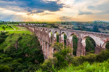 Foto auf gebürstetem Alu-Dibond Landwasserviadukt Aqueduct between mountains at sunset with cloudy sky in arcos del sitio in tepotzotlan state of mexico