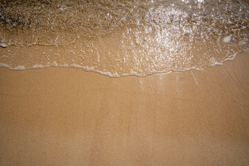 Waves come splashing on the sand beach. High quality photo