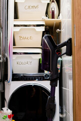 white box on shelf in a laundry room 