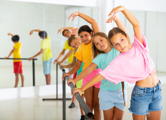 Fototapeta premium Group of children practicing in a ballroom studio